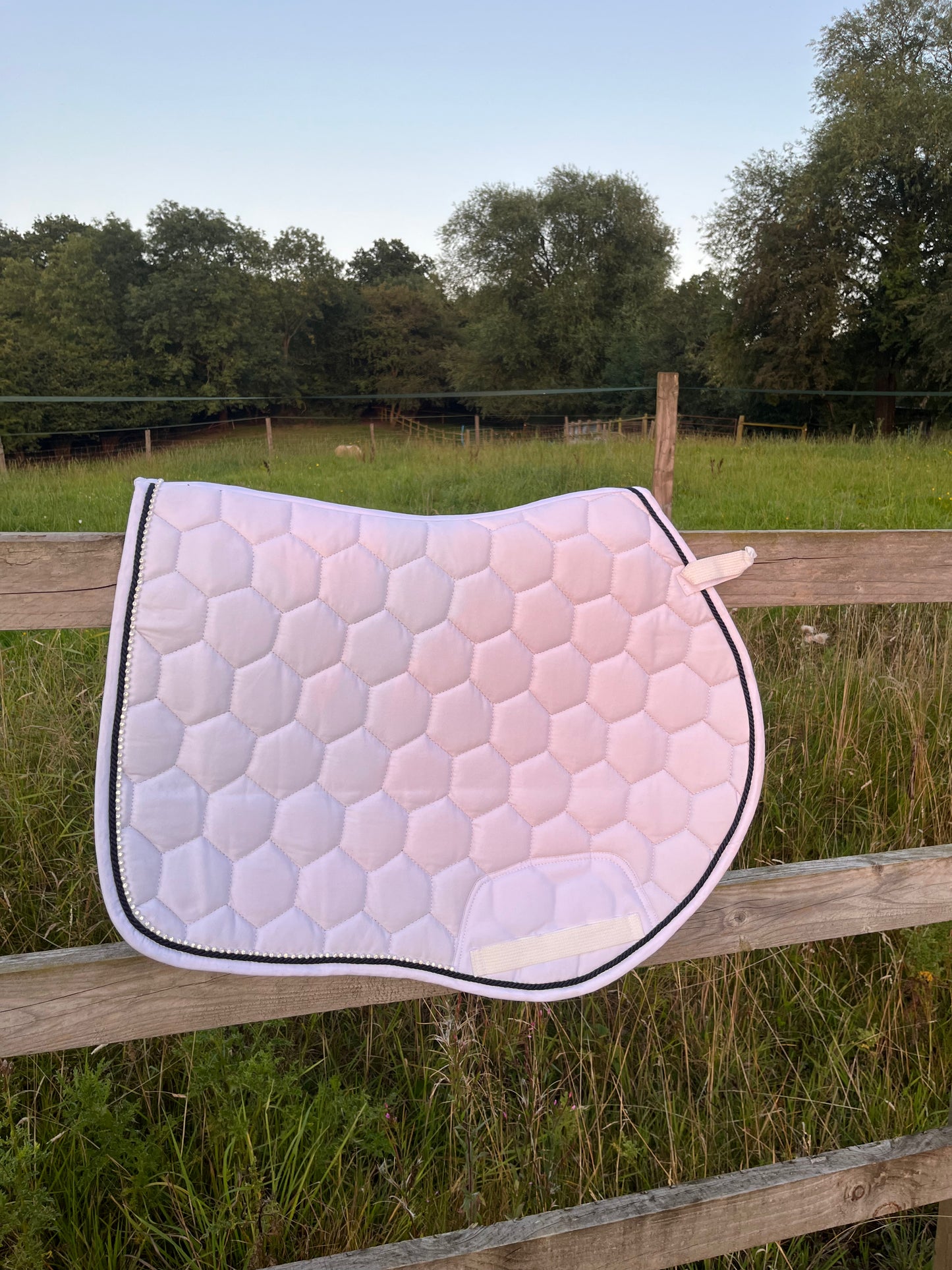 Luxury white cotton competition saddle pad numnah with navy piping and diamontés on it.