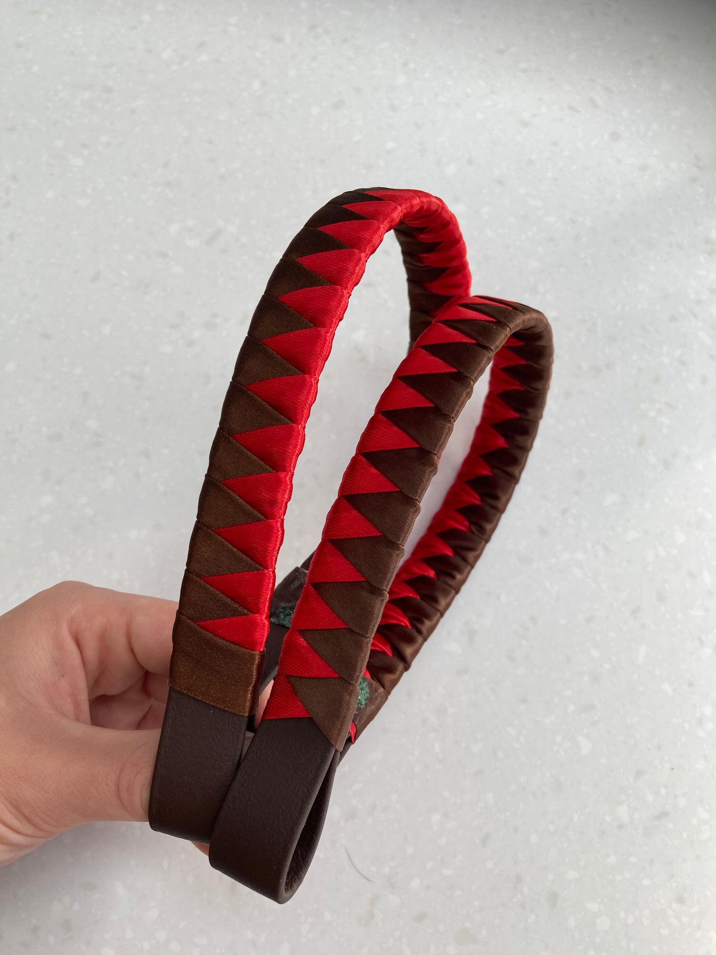 two red and brown bespoke browbands on brown pvc leather