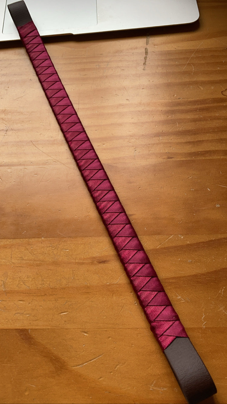 a burgundy bespoke browband on brown pvc leather