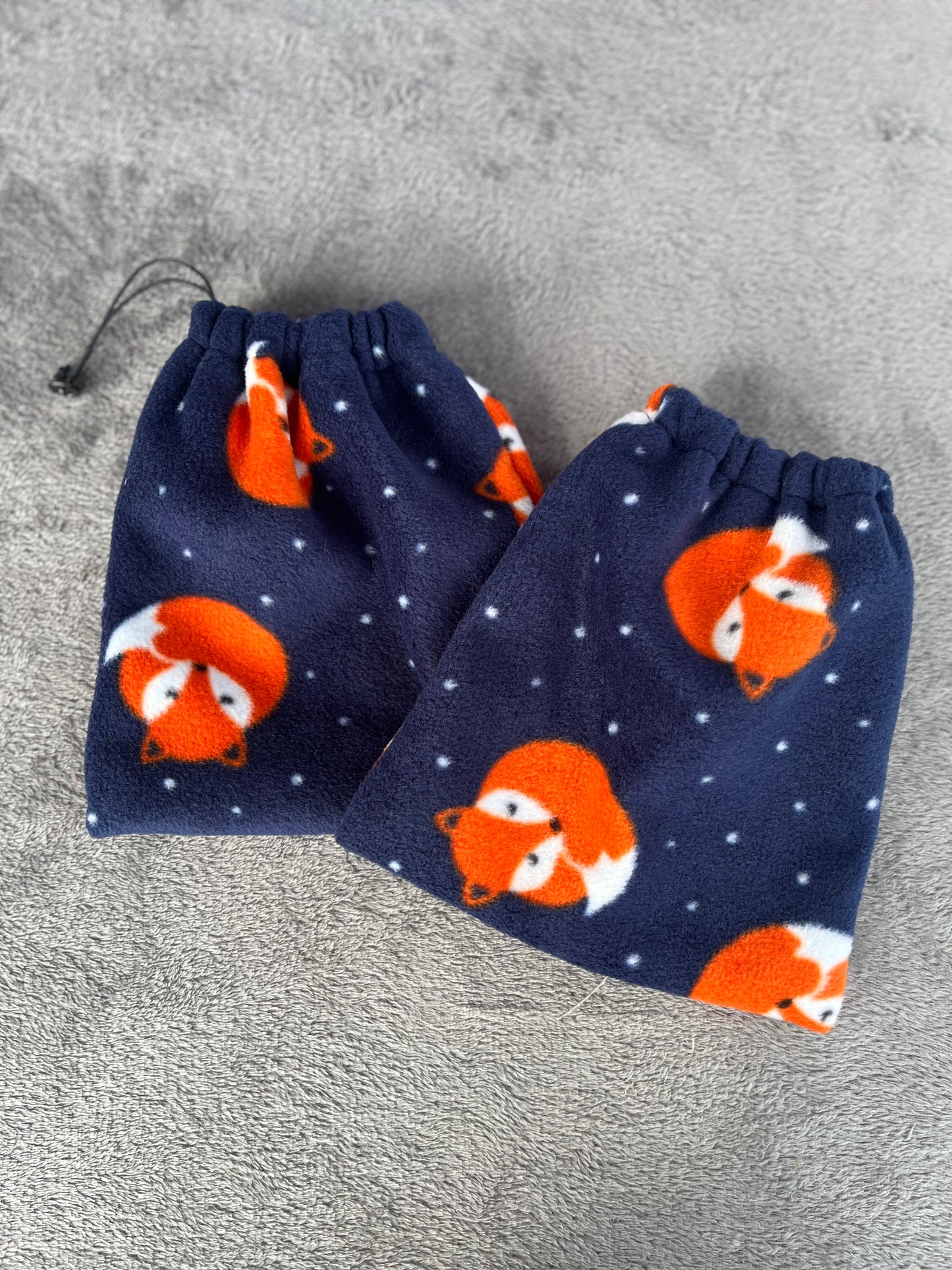 navy stirrup covers with foxes curled up on them 