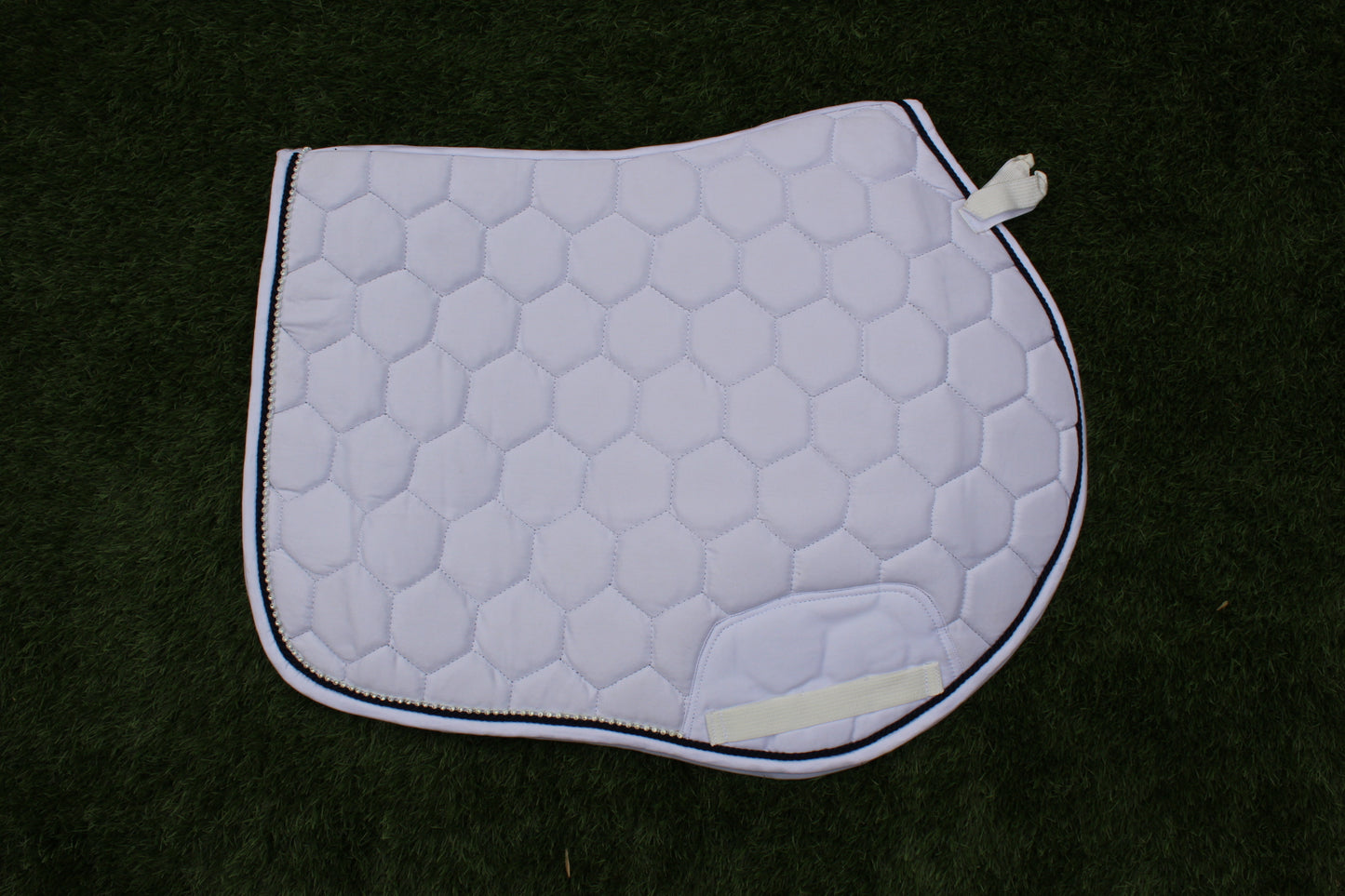 Luxury white cotton competition saddle pad numnah with navy piping and diamontés on it.