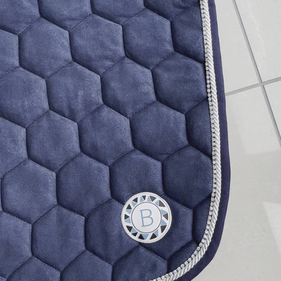 Luxury navy suede competition saddle pad numnah with white piping and diamontés on it.