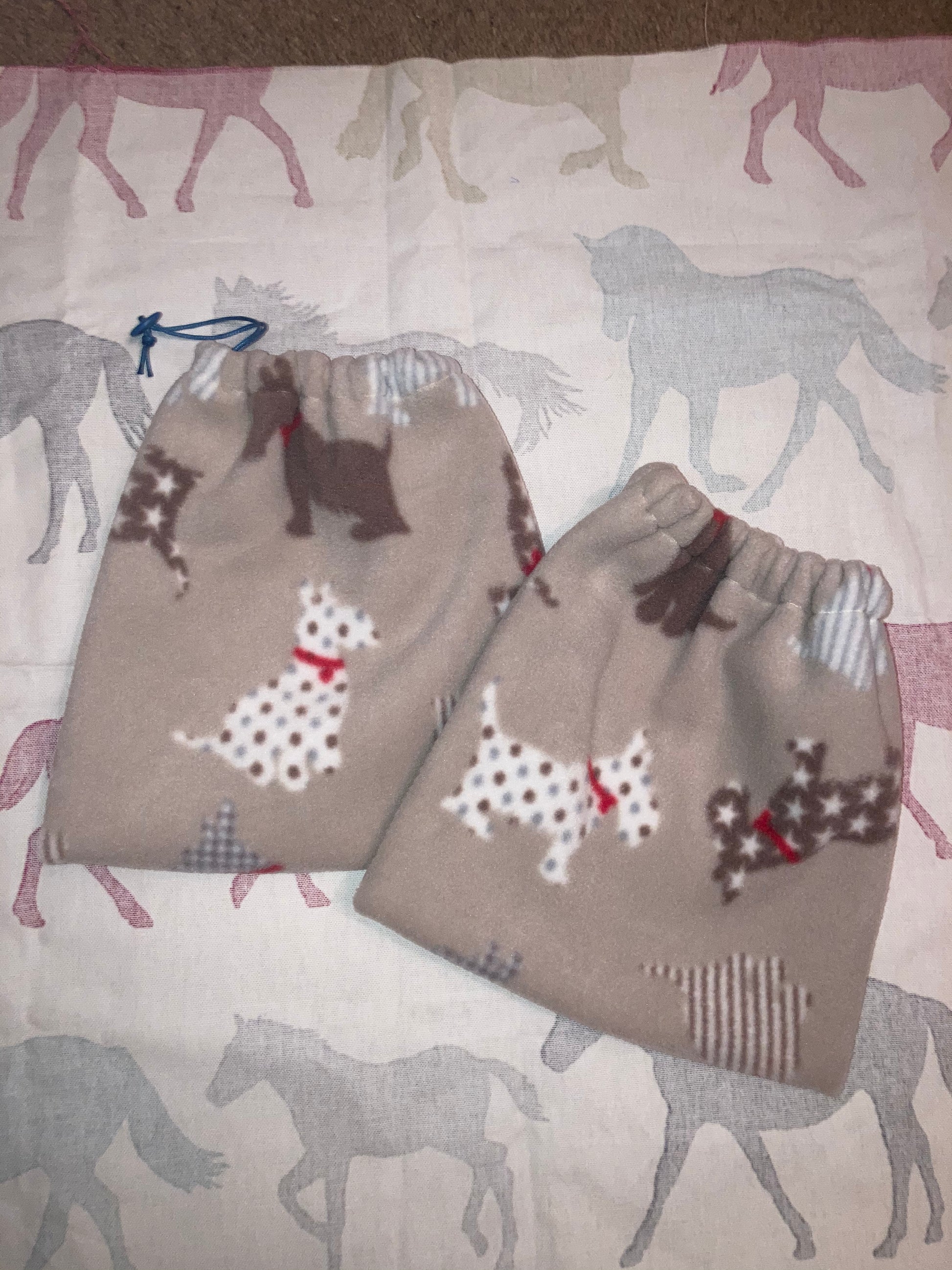 beige stirrup covers with multicoloured Scottie dog on them