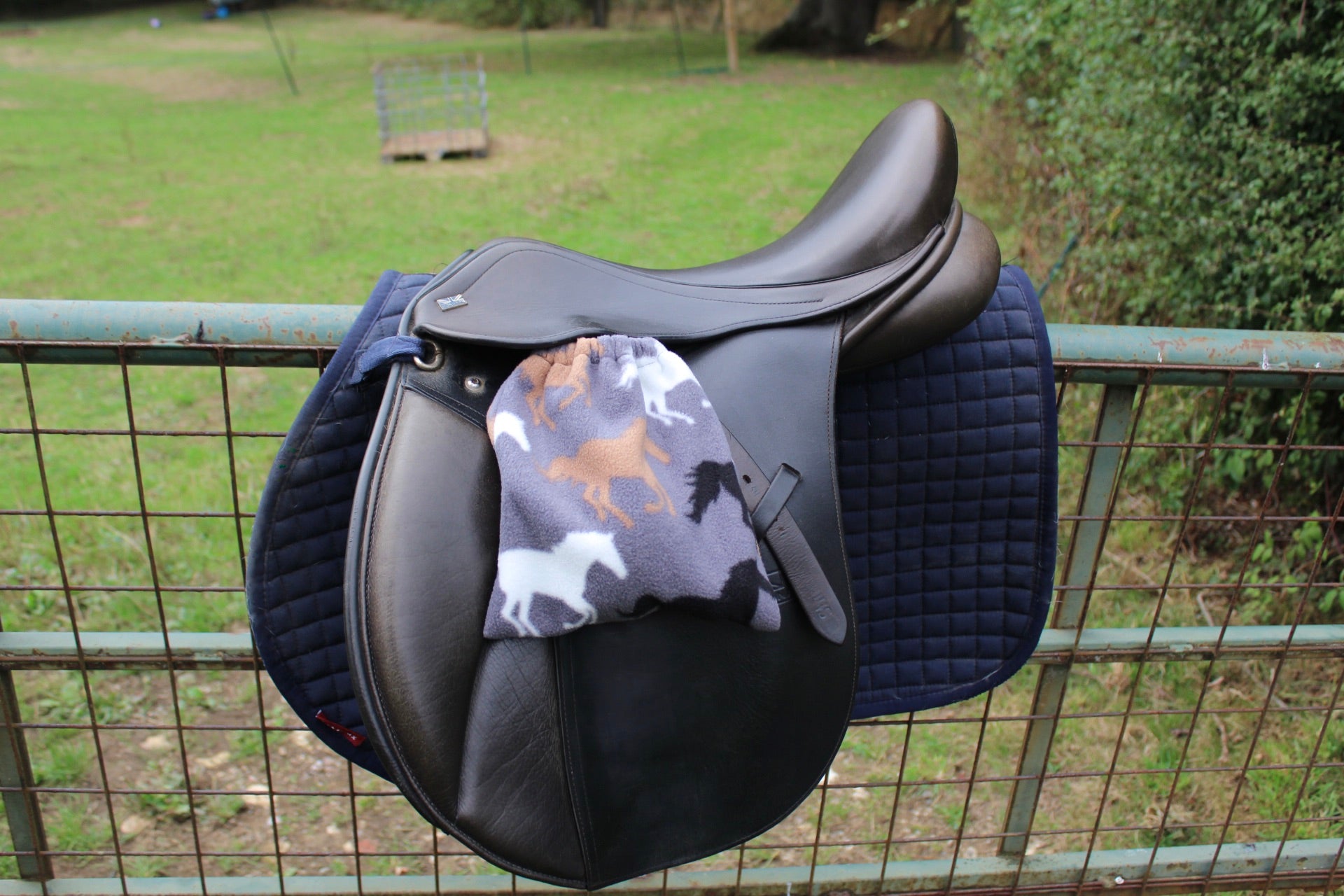 grey stirrup covers with horses on them